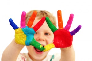 Happy child with painted hands